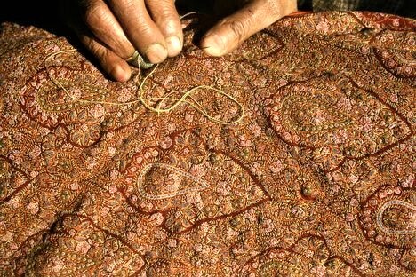 A Pashmina Shawl is getting embroidered by a skillful Master